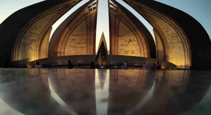 Symmetrical reflection of the Pakistan Monument architectural petals on the marble floor during sunset in Islamabad.