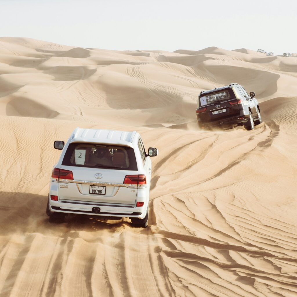 "Toyota Land Cruisers dune bashing in the Dubai desert."