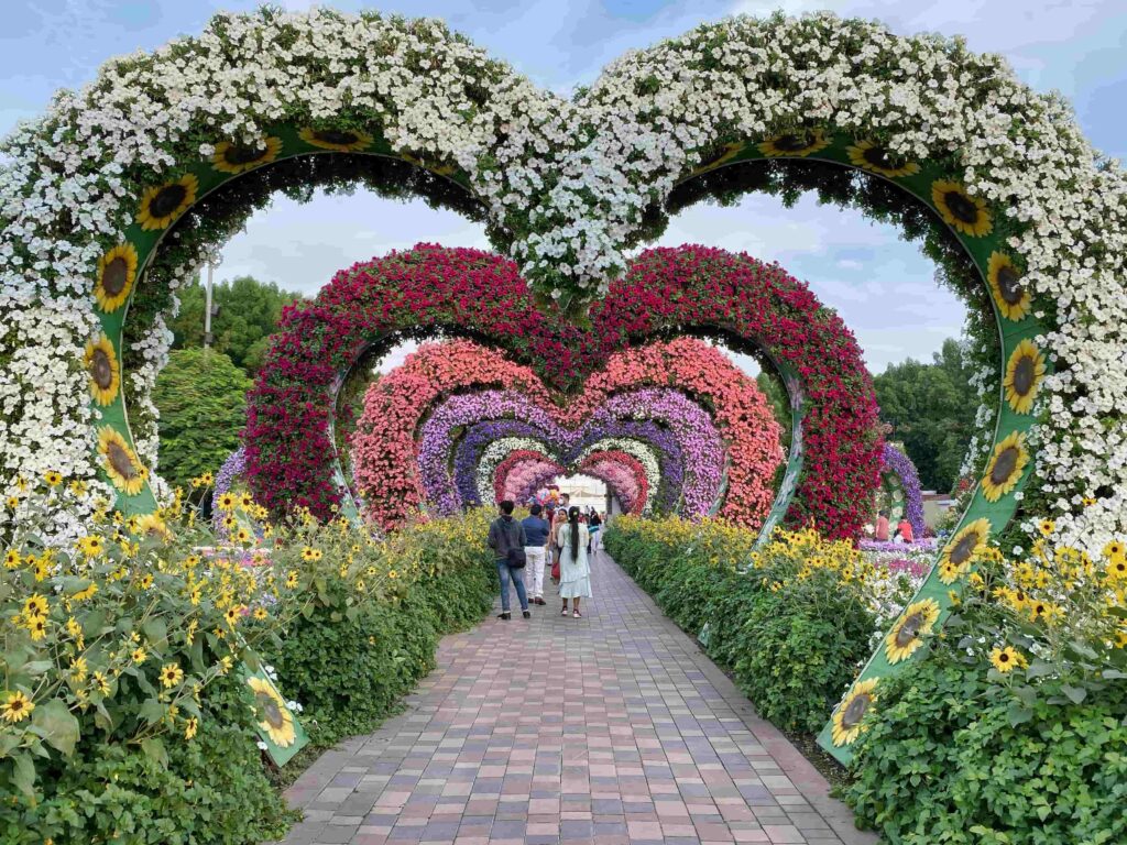 Beautiful flower-covered heart-shaped arches at Dubai Miracle Garden.
