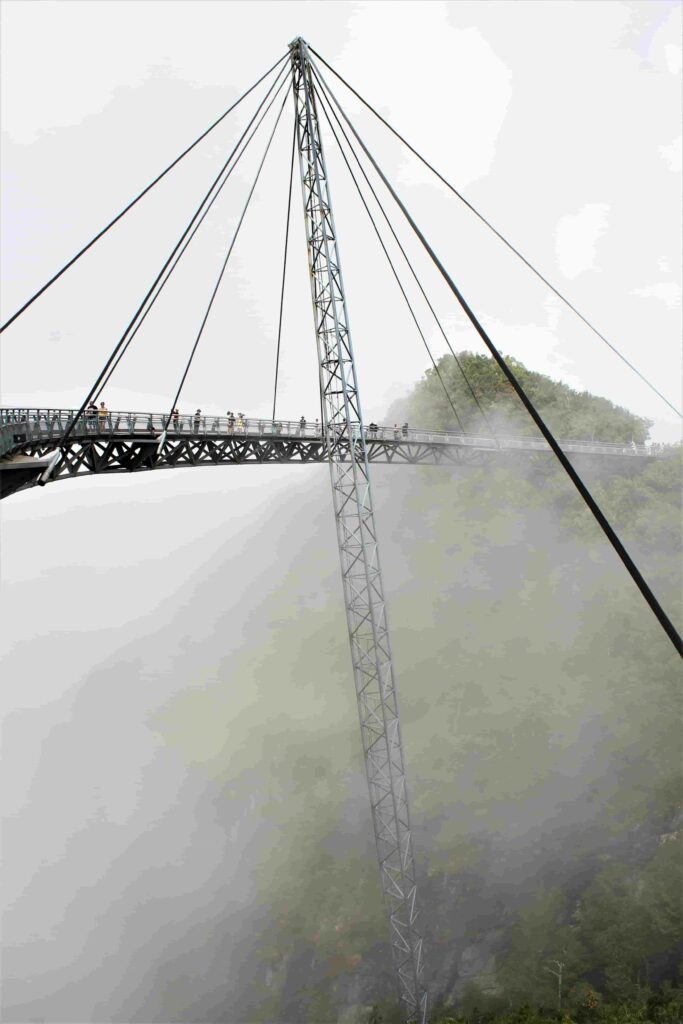 Langkawi Sky Bridge curved pedestrian walkway emerging through clouds and mist high above Langkawi island Malaysia Langkawi Sky Bridge

