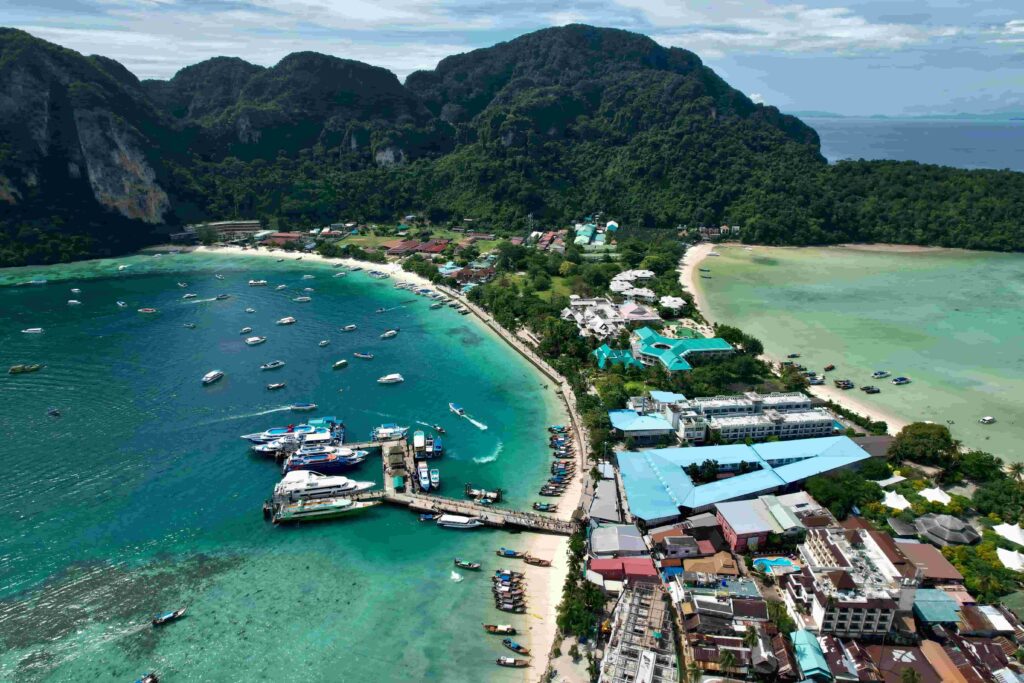 Aerial drone shot of Tonsai Village pier and boats in Phi Phi Island Thailand