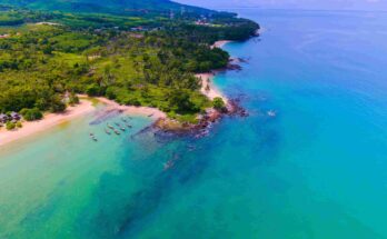 Aerial view of Yona Beach Koh Lanta Thailand with turquoise water longtail boats and lush green coastline