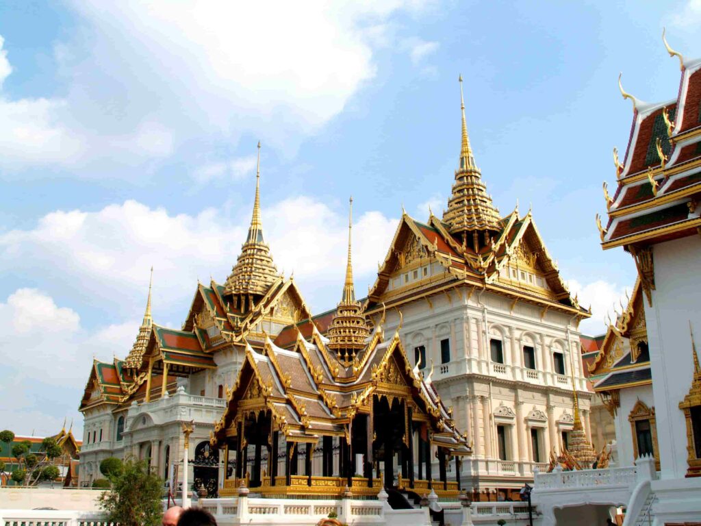 Chakri Maha Prasat European architecture and golden spired roofs at the Grand Palace Bangkok.