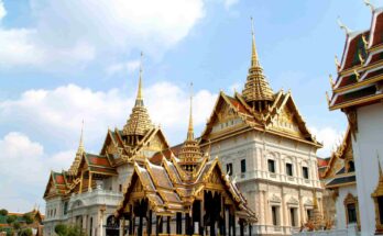 Chakri Maha Prasat European architecture and golden spired roofs at the Grand Palace Bangkok.