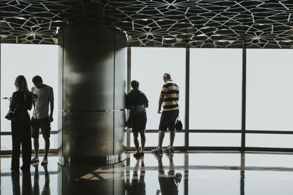 Tourists enjoying the panoramic city view from Burj Khalifa observation deck