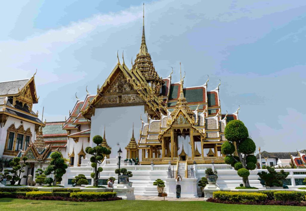 Traditional Thai temple pavilions and manicured gardens inside the Grand Palace Bangkok complex.