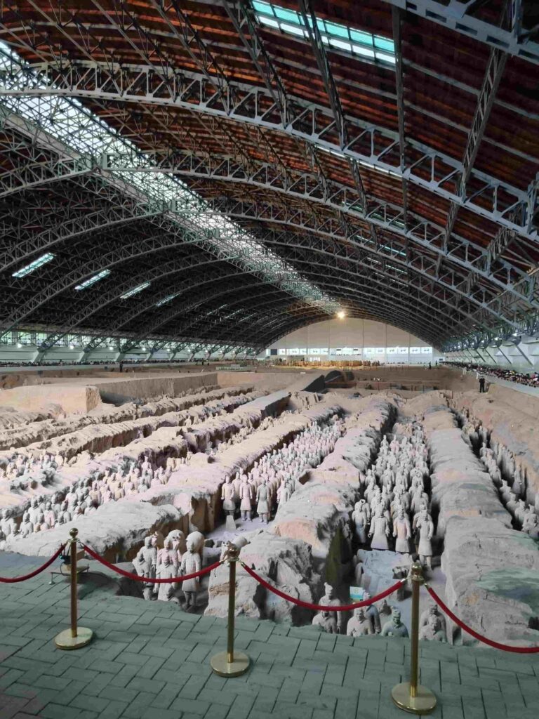 Life-sized terracotta soldiers standing in precise battle formation inside the Terracotta Warriors Museum