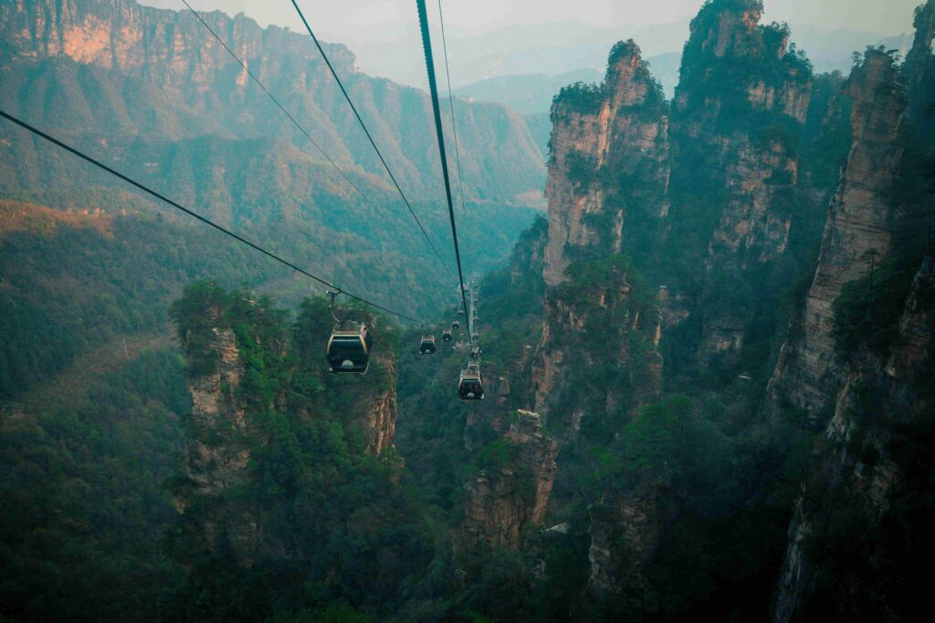 Cable cars floating between giant sandstone pillars in Zhangjiajie National Forest Park China — the real-life Avatar mountains