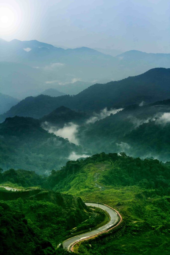 Winding mountain road through misty rainforest on the drive up to Genting Highlands, Malaysia